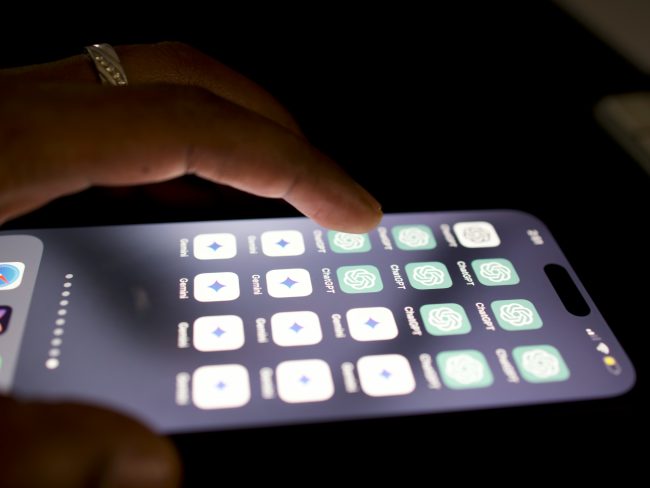 Close up of a smart phone and someone pressing an app.