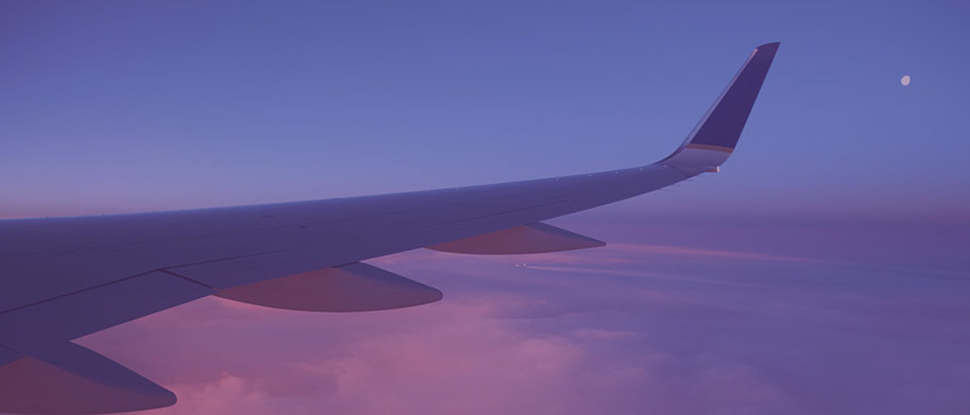Wing of an aeroplane in the sky above clouds