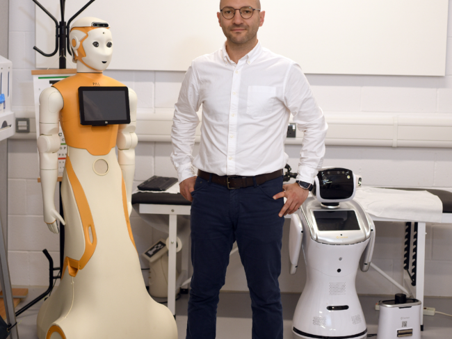 Prof Ibrahim Habli and a robot